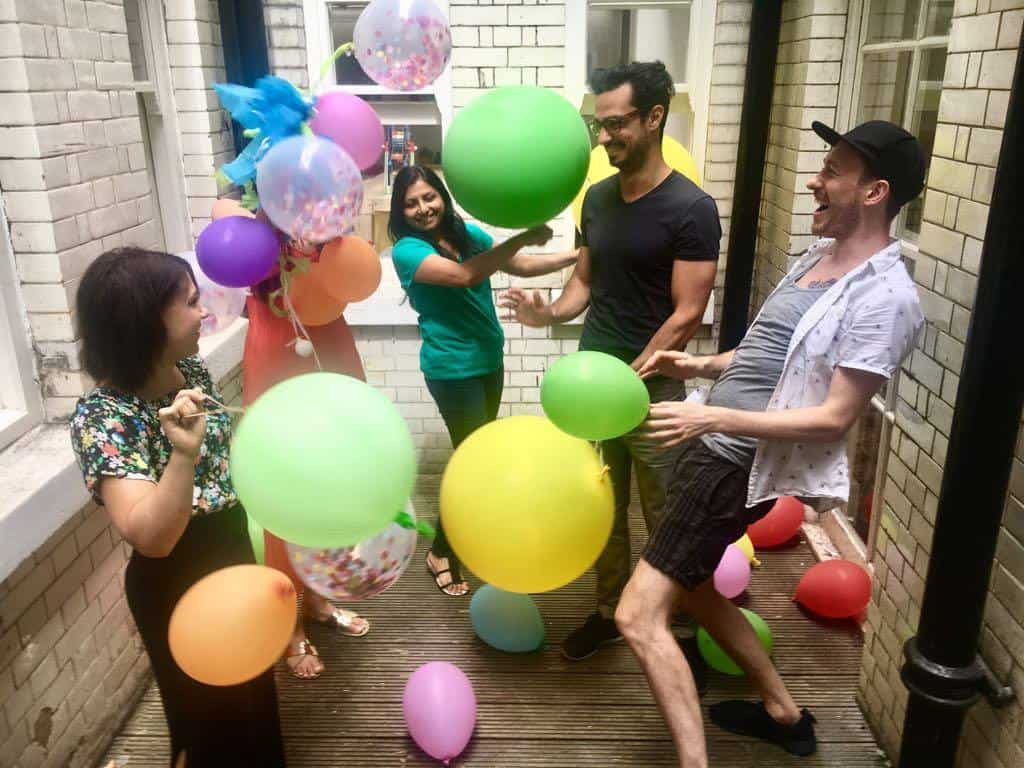 People messing around with balloons
