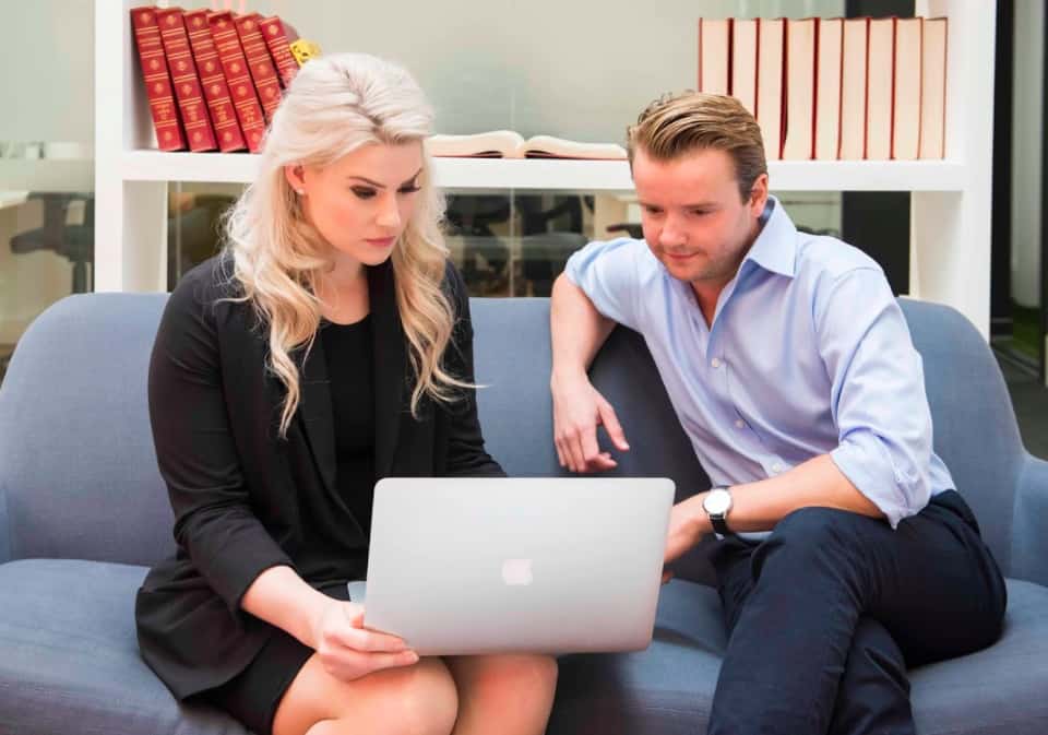 Two business people looking at a laptop